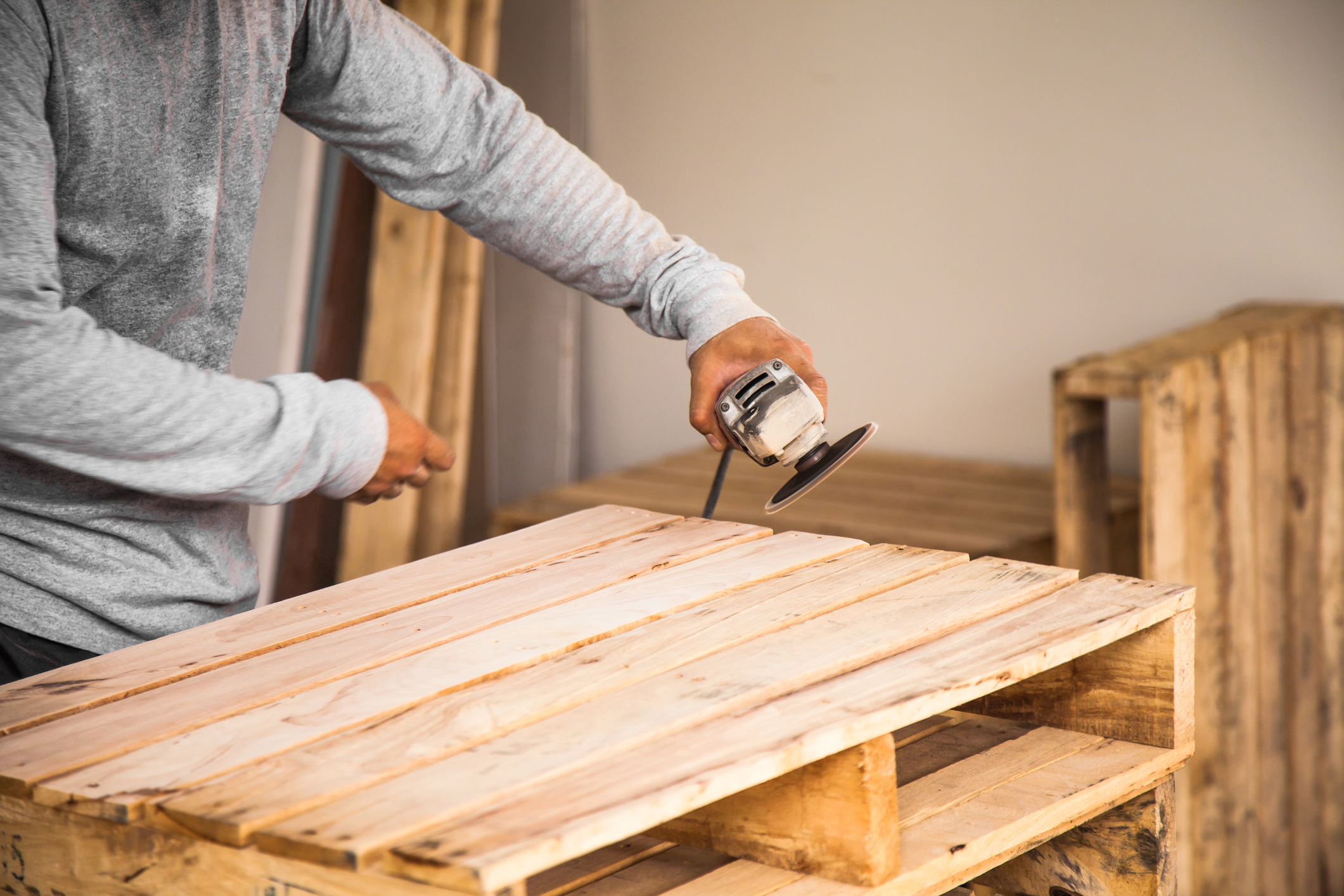 man with machine repairing pallet 